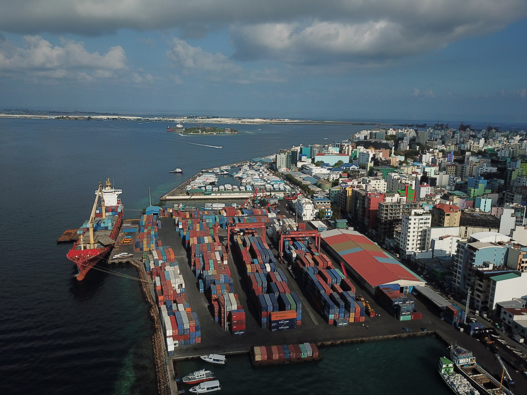 Cargo vessels and activity along Malé’s commercial harbour